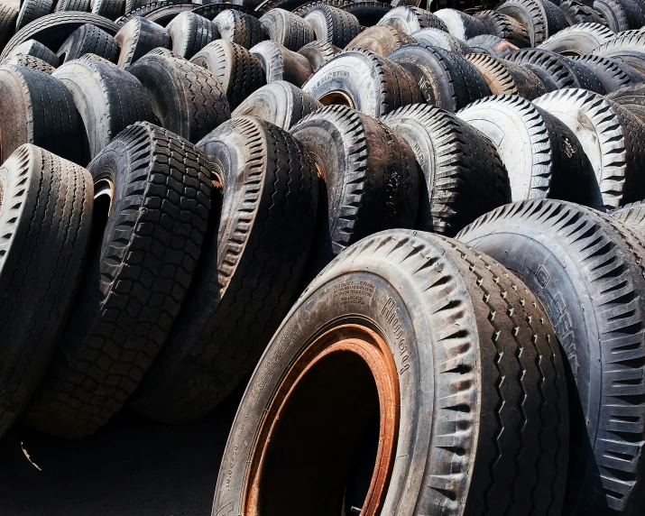 rows of tires are stacked together on the ground