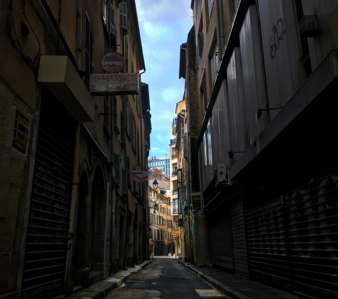 a street view of a line of buildings in a narrow alley way