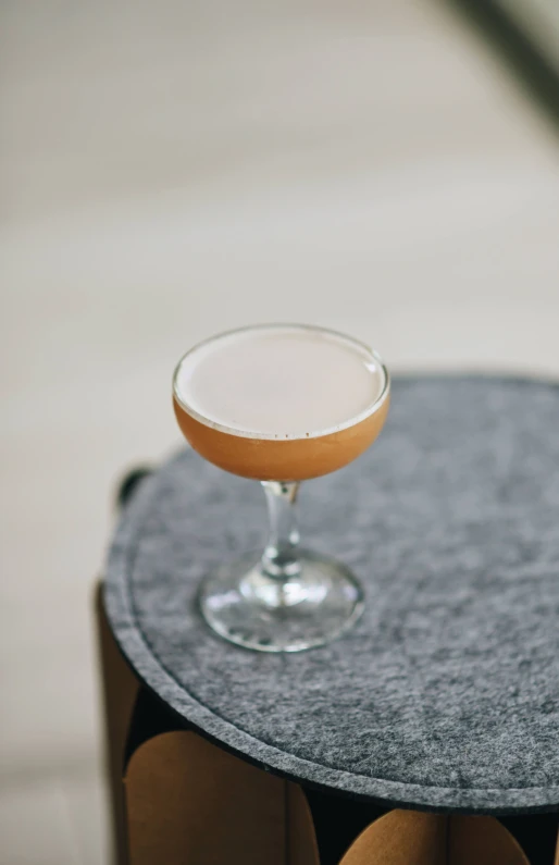 a cocktail sitting on a round table