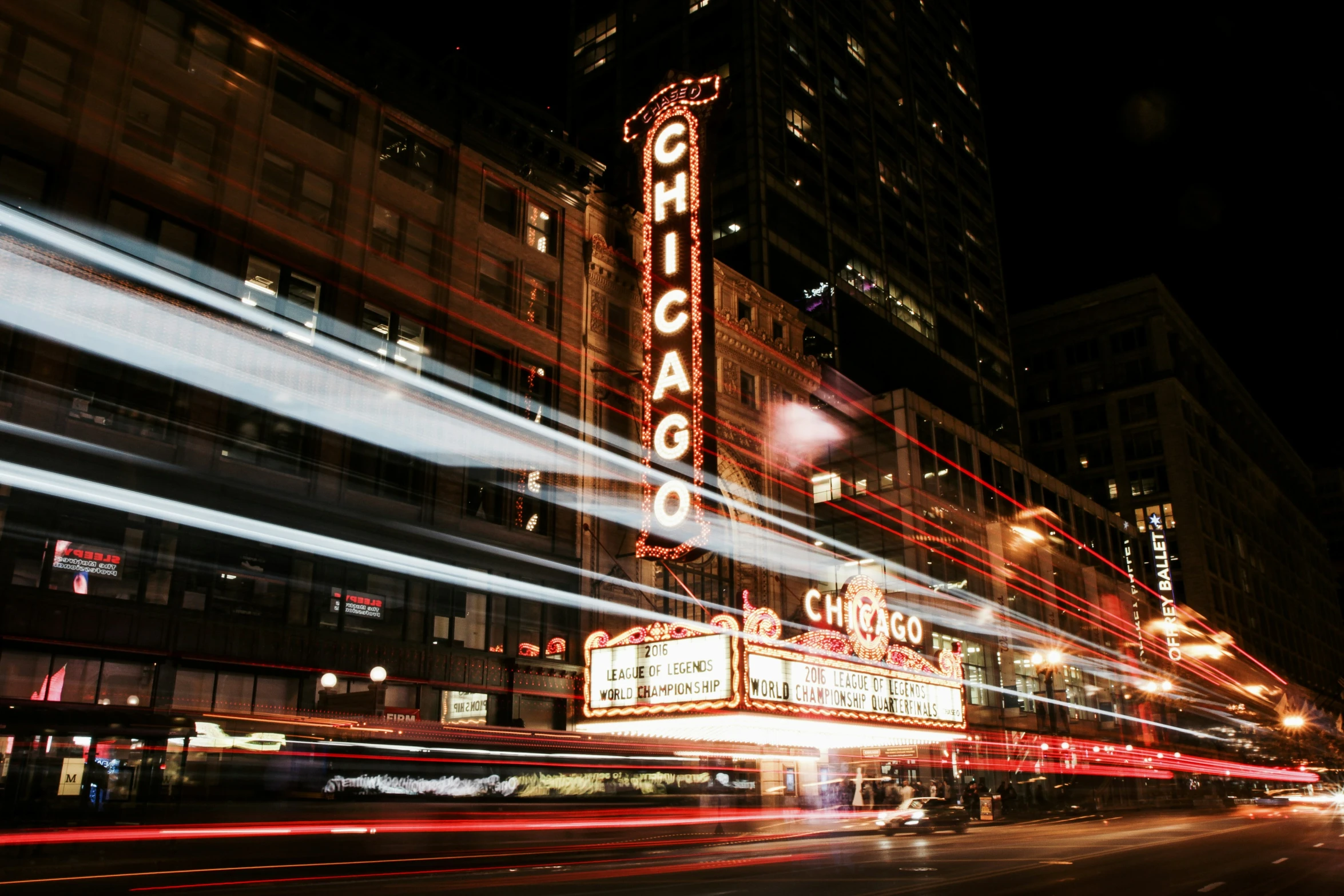 a movie theater sign is lit up by the night