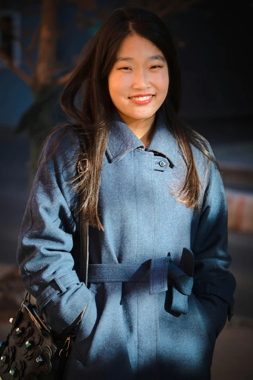 a woman in blue clothes smiling at the camera