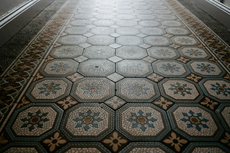 a long tiled hallway with decorative floor tiles