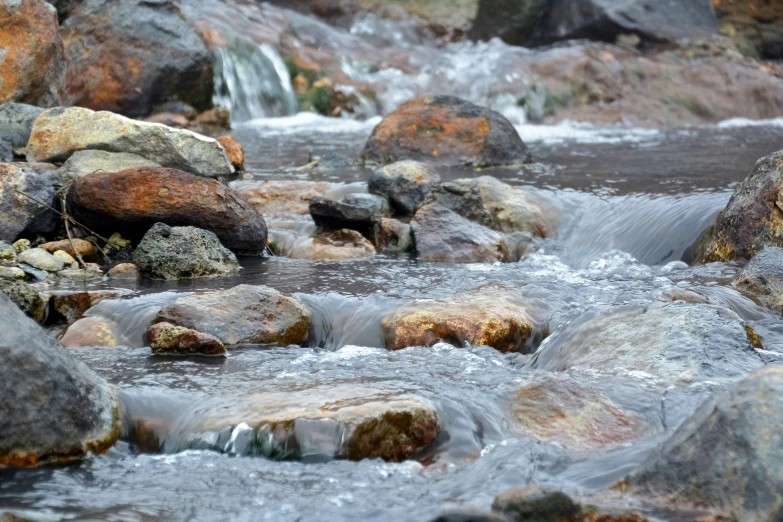 water flowing through the stones and boulders in a river