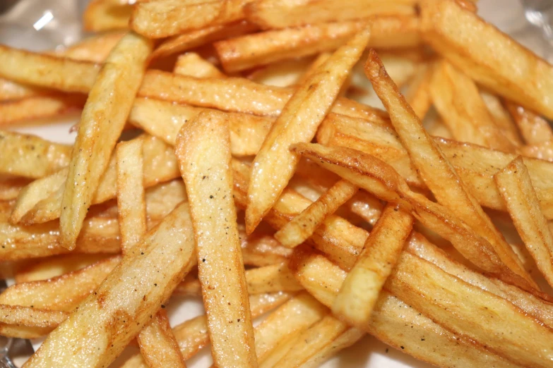 some very thin fries are on a plate