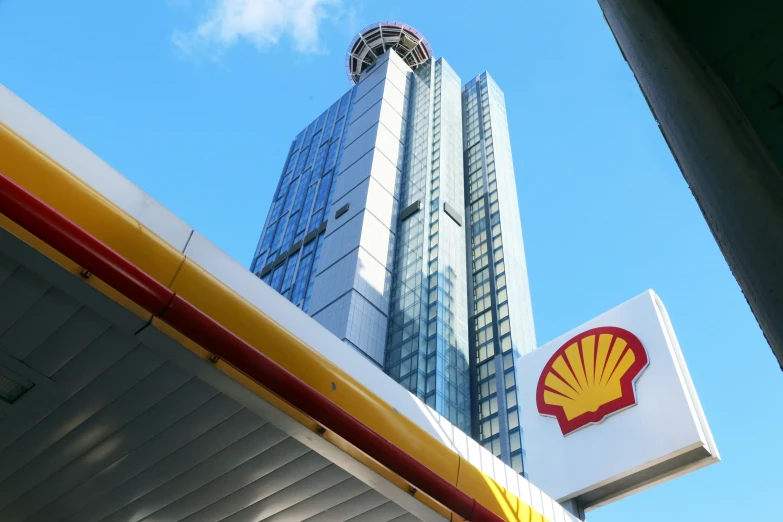 a shell company building and a sign at a gas station