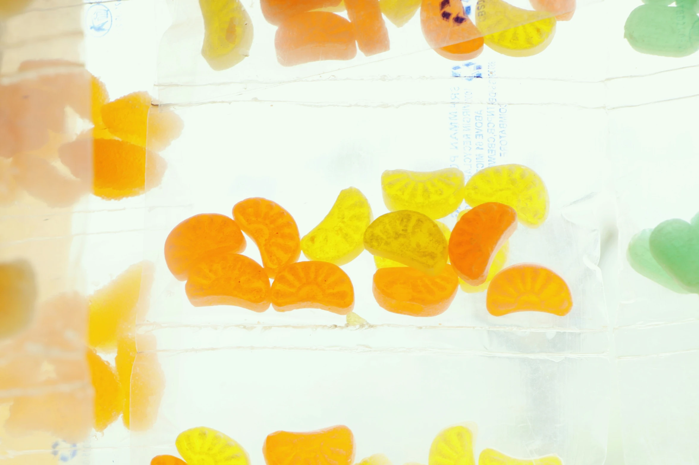 the gummy bears are lined up against the white wall