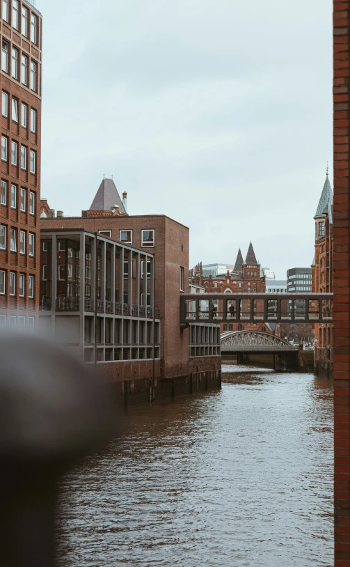 the waterway near several buildings has brown water