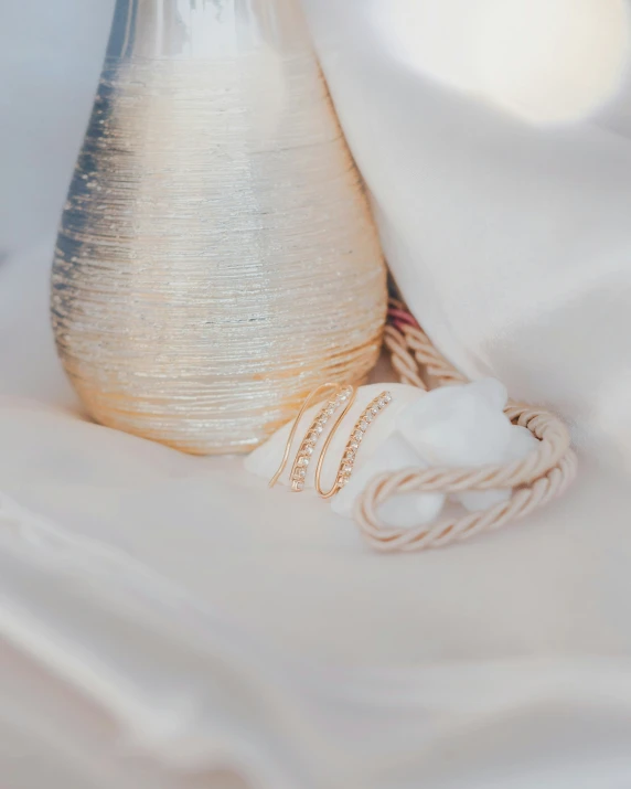 an old white vase with a cord laying next to it