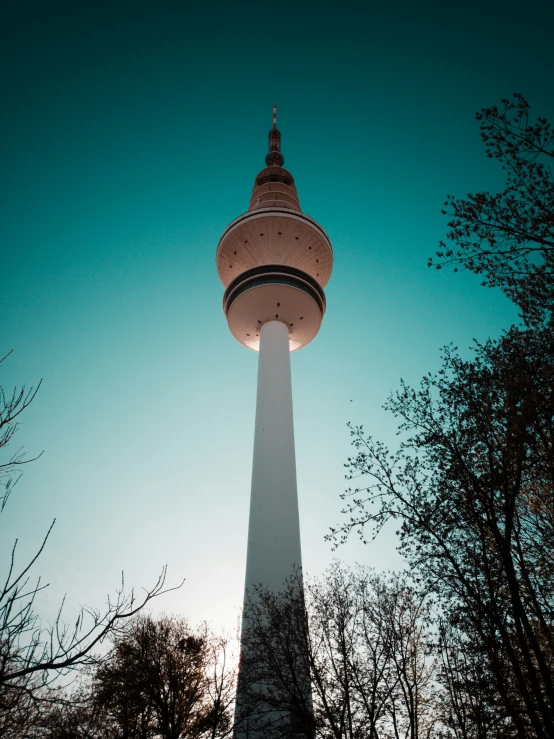 a tall white tower with a clock on it's top