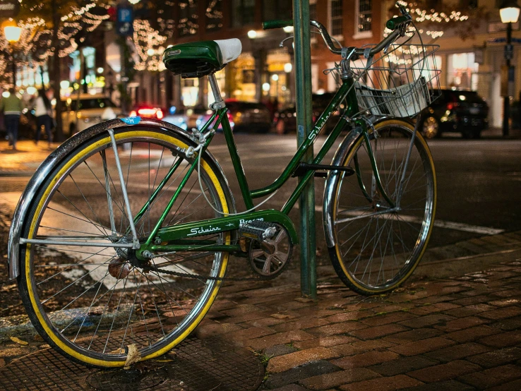 a parked green and yellow bike on the side of the street