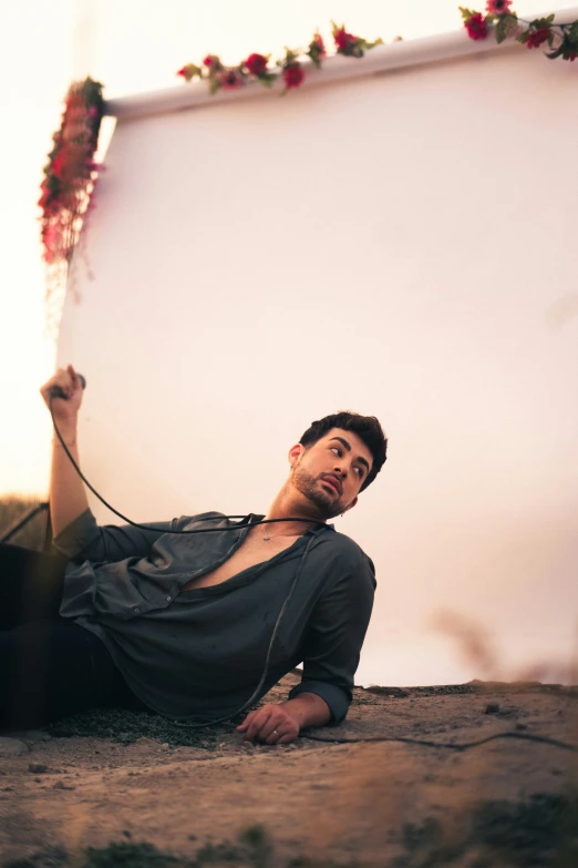 a young man lying in the middle of a road