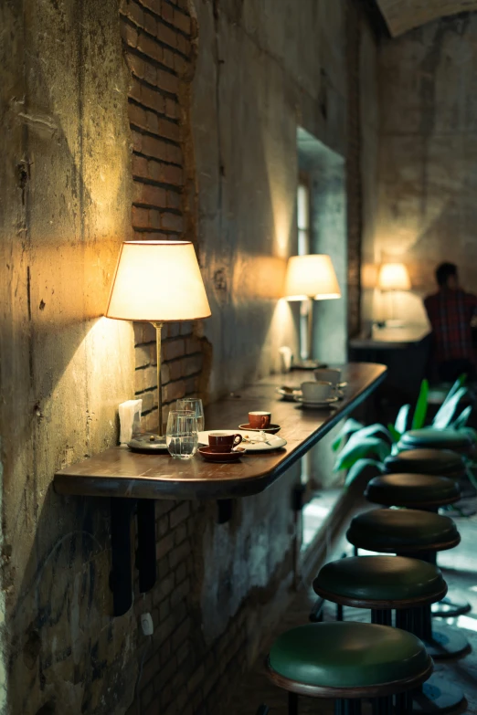 there is a long bar with stools around the table