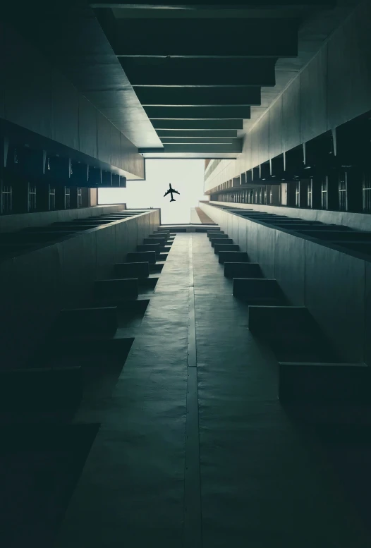 an airplane is soaring above a darkened airport