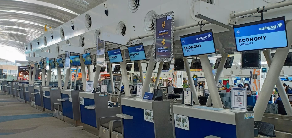 a row of luggage carts in an airport