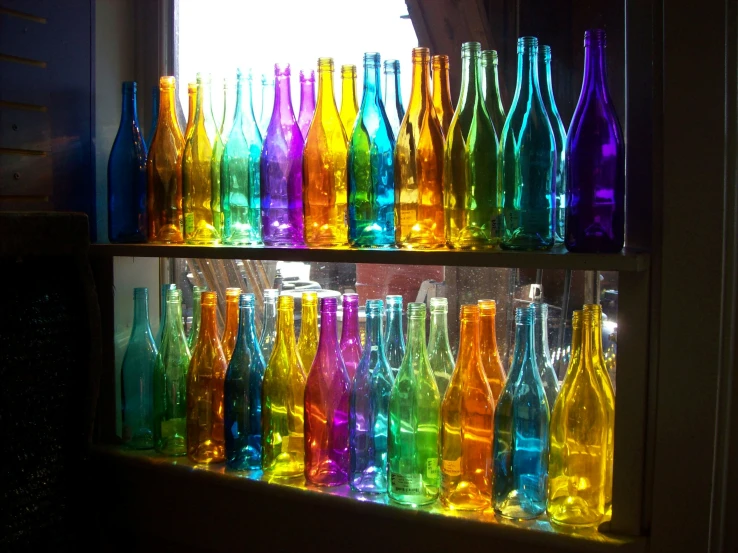 colorful glass bottles are displayed on a wall