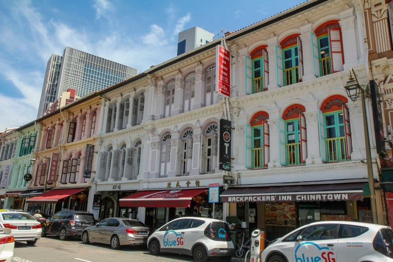 a building on a street corner with colorful windows