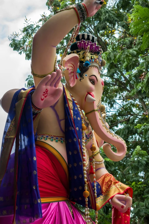 a statue of an elephant is wearing some costume