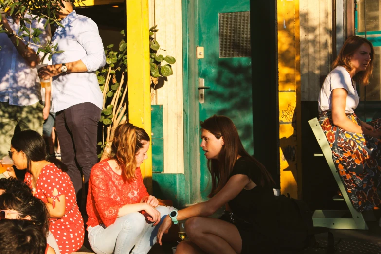 several people sitting outside near a building