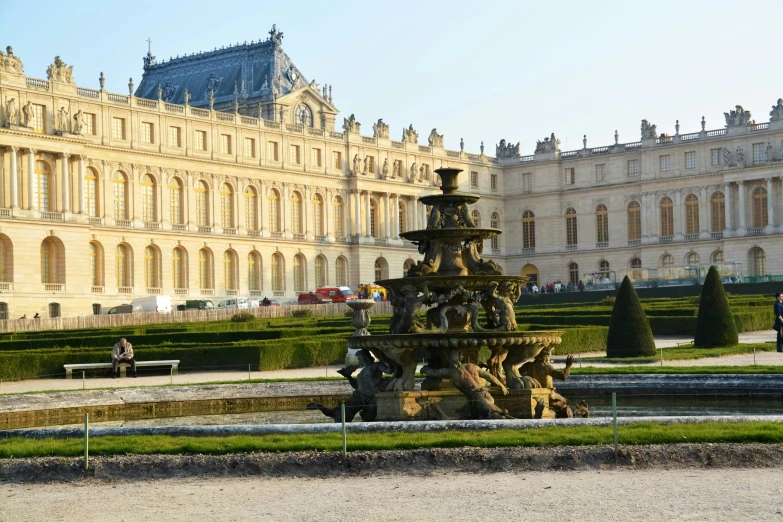 the large ornate garden area has a fountain