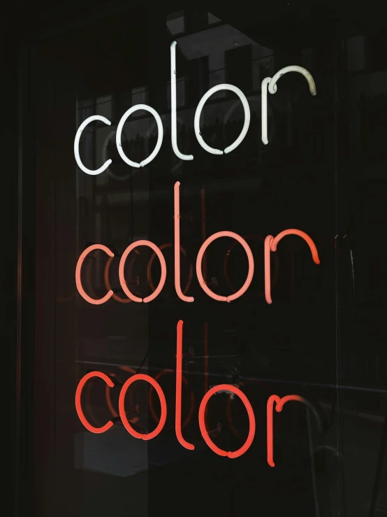 a red neon sign is seen inside the window