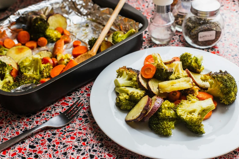 the broccoli dish is on the plate with carrots and potatoes