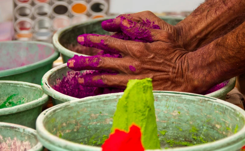 a person has their hands on some dirt