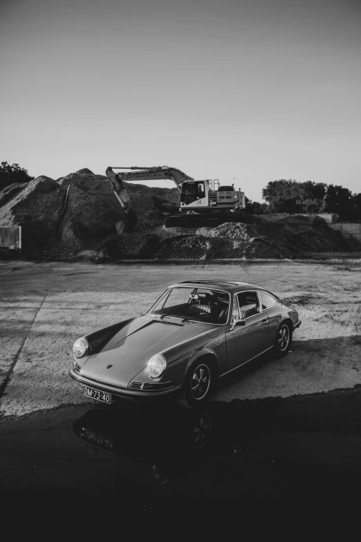 black and white pograph of a car parked in parking lot