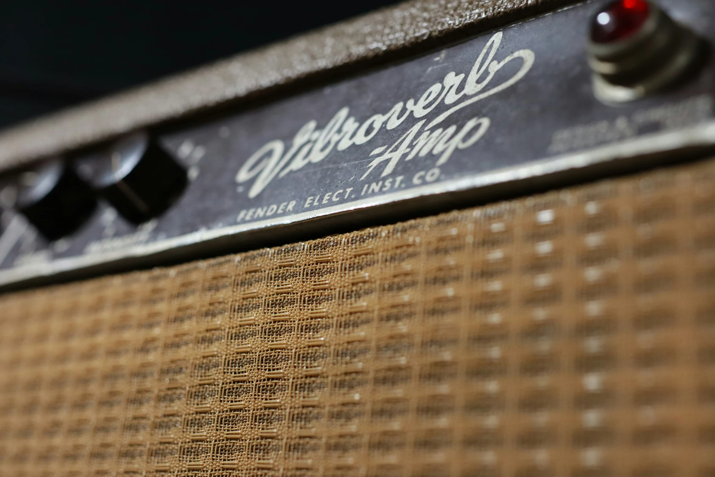 an amp with some red s and a black cap