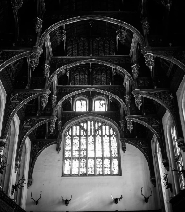 the inside of a gothic building with an arched window