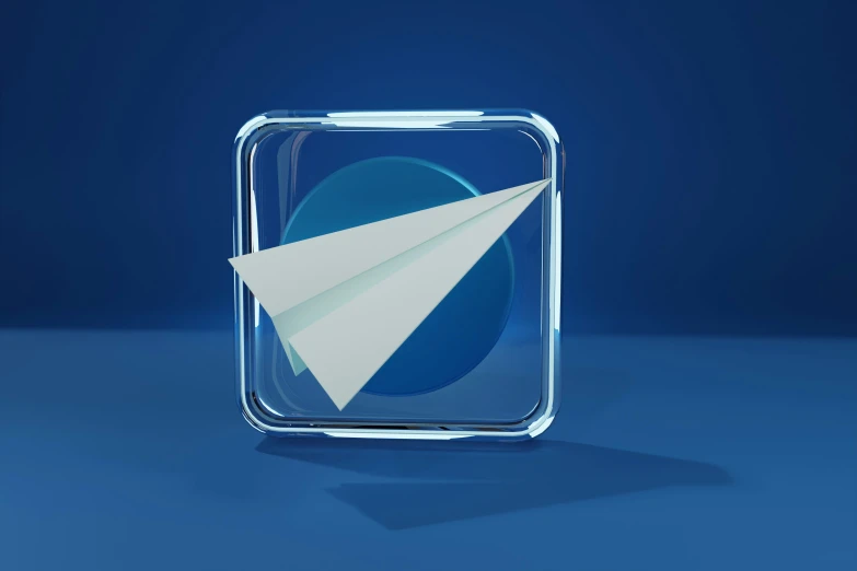 a paper plane sitting in a square shaped glass container