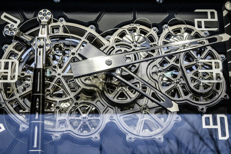 a close up of a wall clock made of gears