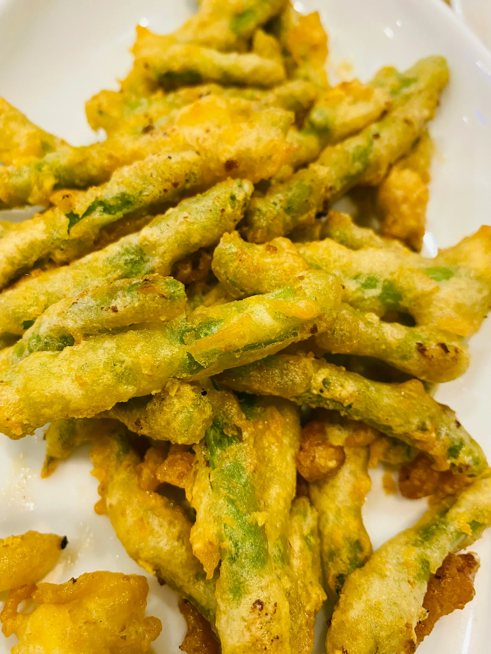 this plate has asparagus and fried cheese on it