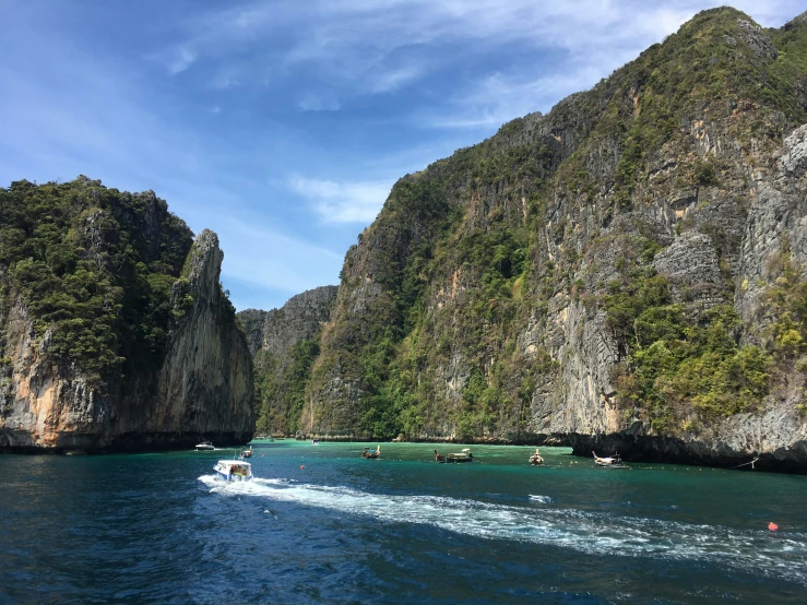 several boats with people in them are on the water