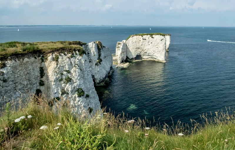 a group of large rocks sitting on the side of a cliff