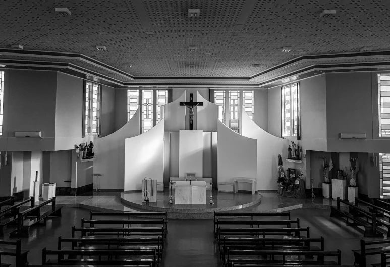 a church with pews, a cross and two windows