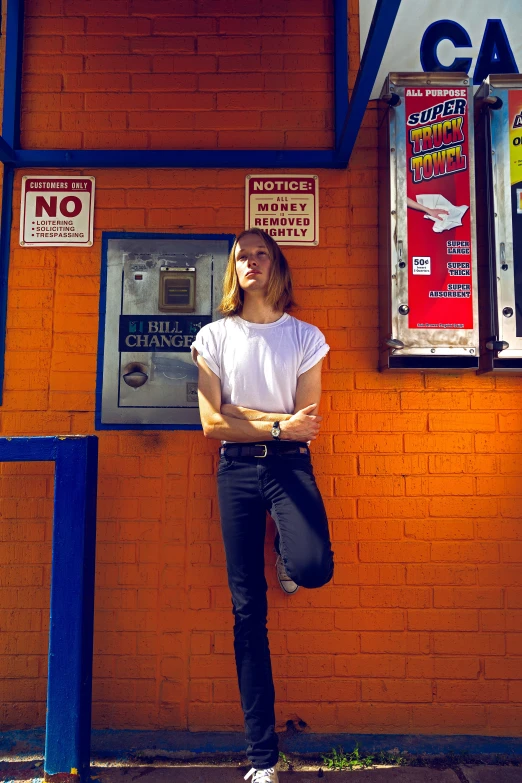 a woman posing for a po next to an atm machine