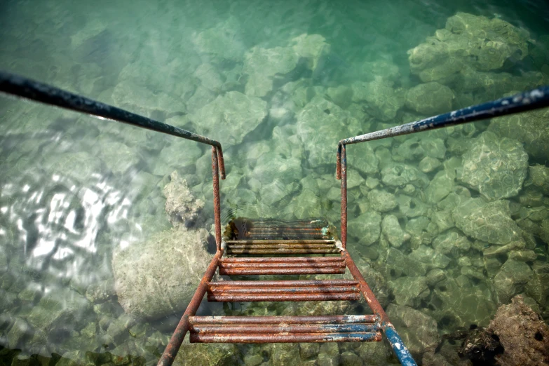 two rusty rusted steel walkways and metal bars floating down a lake