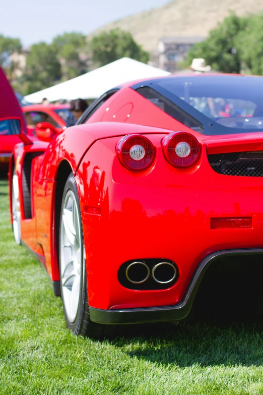 a red sports car is parked in the grass