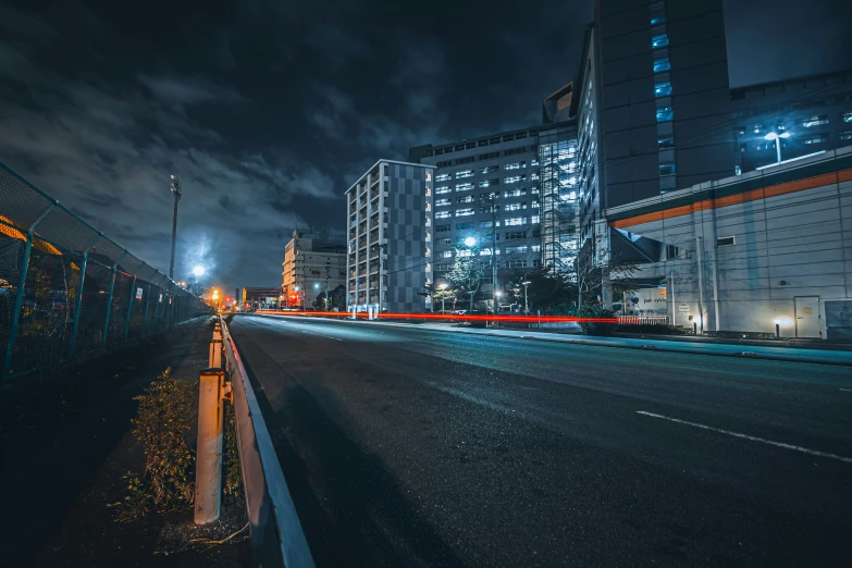 a long - line of buildings and street lights at night