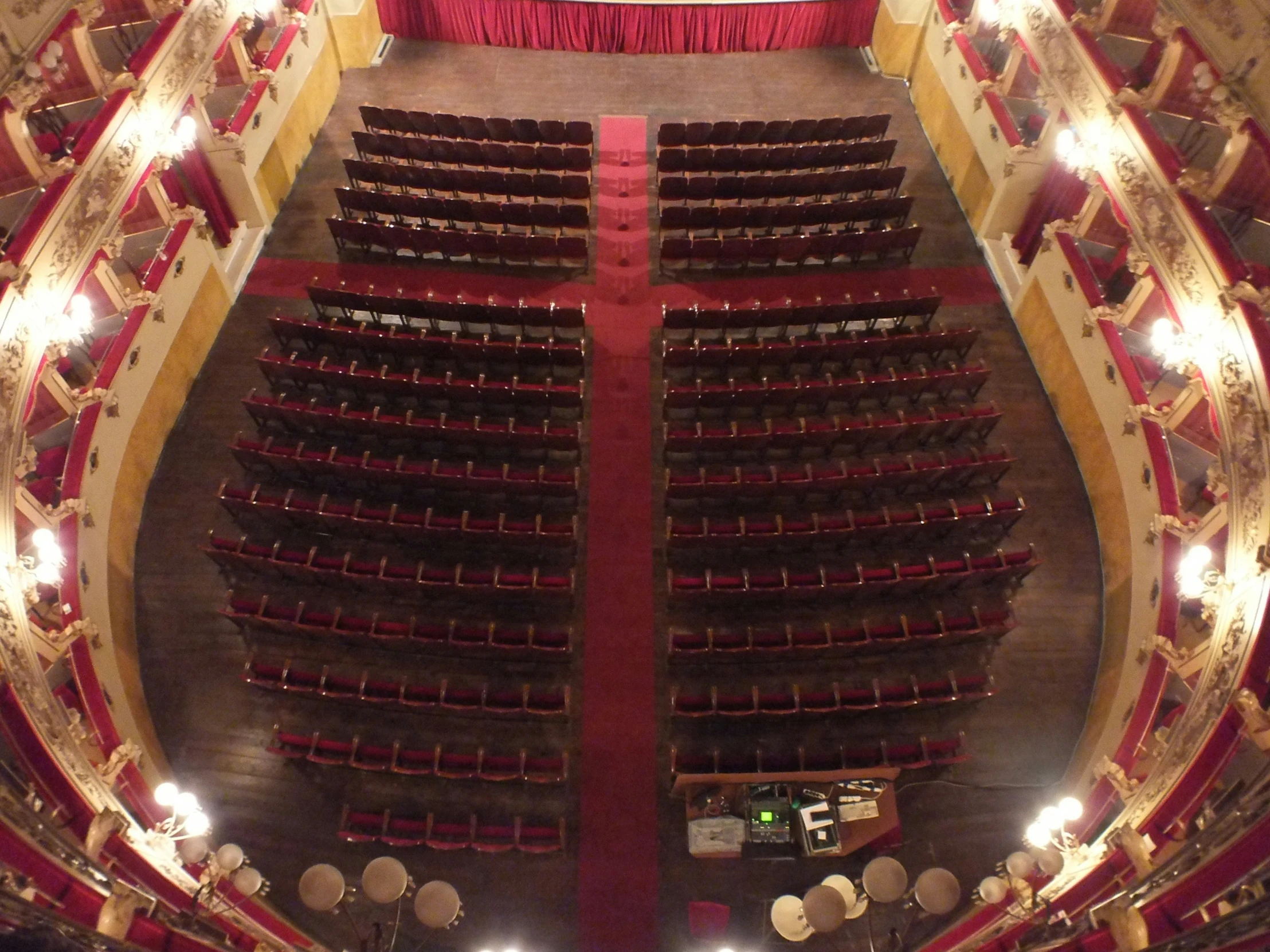 an empty theatre with lots of seats on the sides