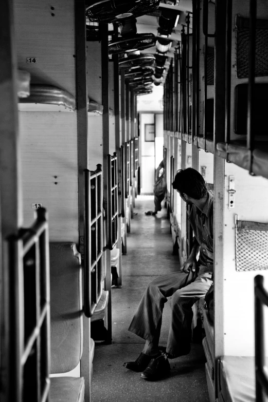 a person sits on the ground inside a train