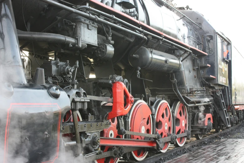 a locomotive train on the tracks blowing steam