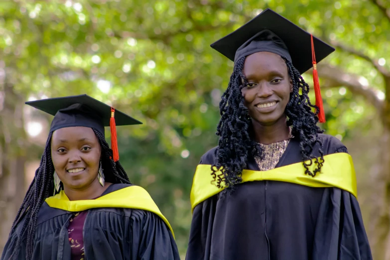 two women in cap and gowns standing together