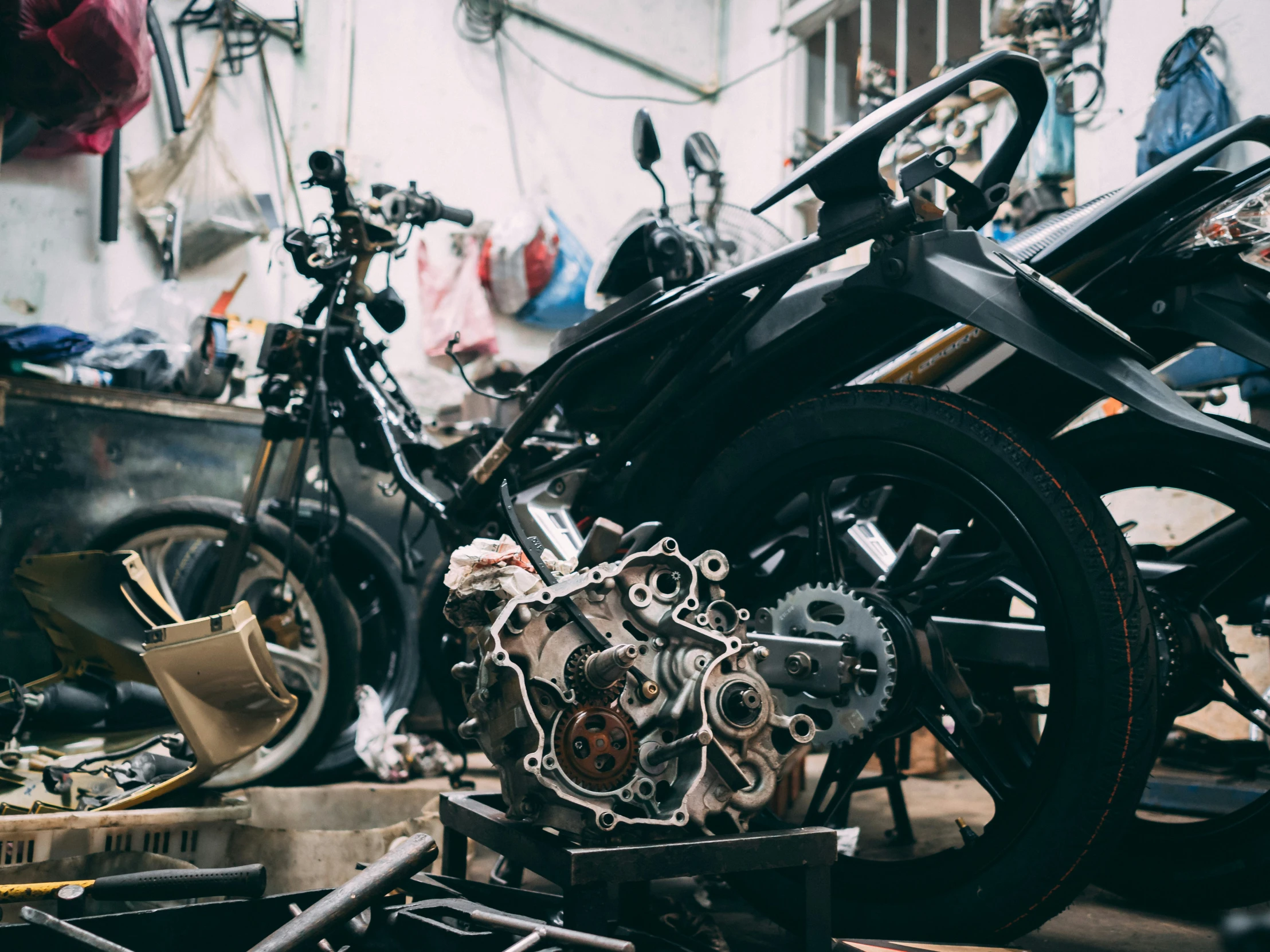 a bicycle parked on top of a floor next to a pile of tools