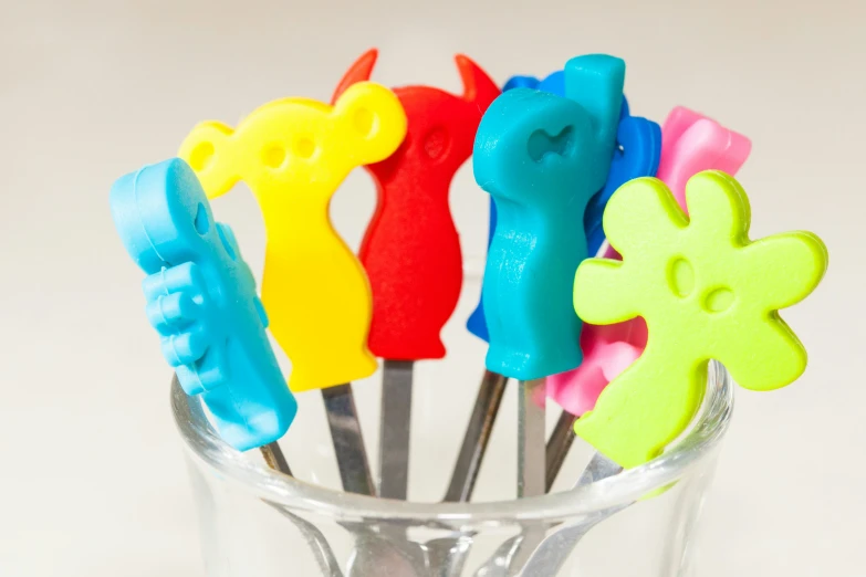 some scissors in the shape of flowers are arranged in a cup