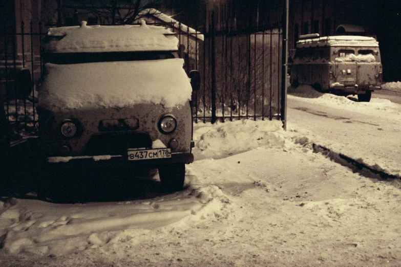 an old car that is parked in the snow