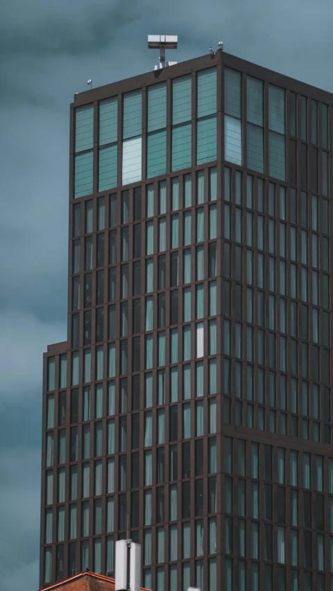 a tall building sitting next to a red brick building