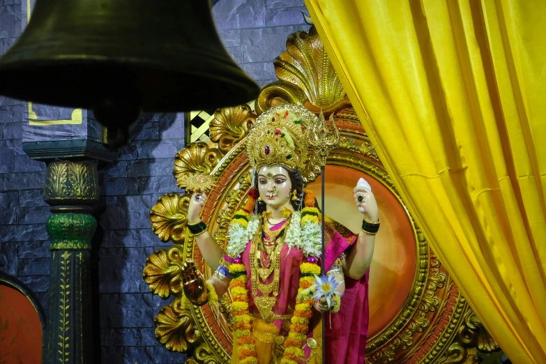 the statue of an indian god is shown in front of a wall