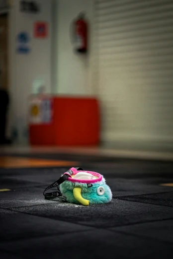an empty, unliten stuffed toy in front of a garage