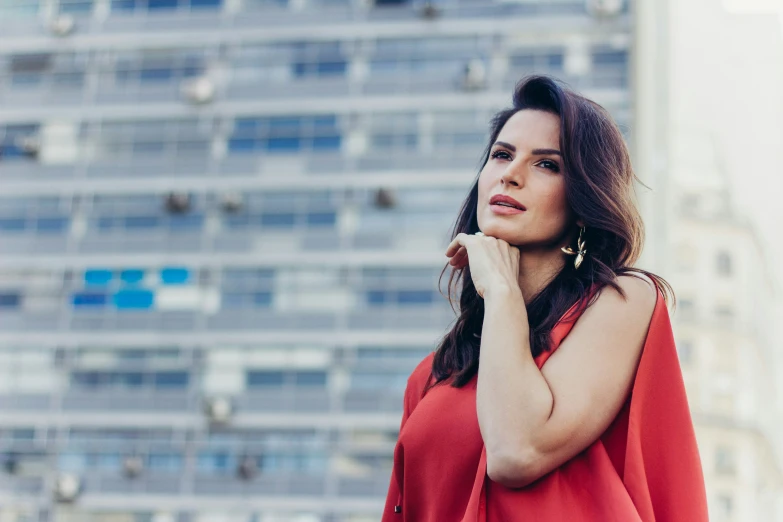 woman in a red dress talking on her phone